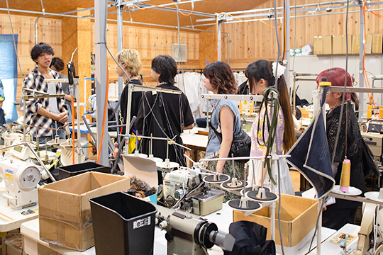 サンプル製作のアトリエを見学する織田ファッション専門学校ファッションデザイン専攻科とファッションテクニカル専攻科の学生